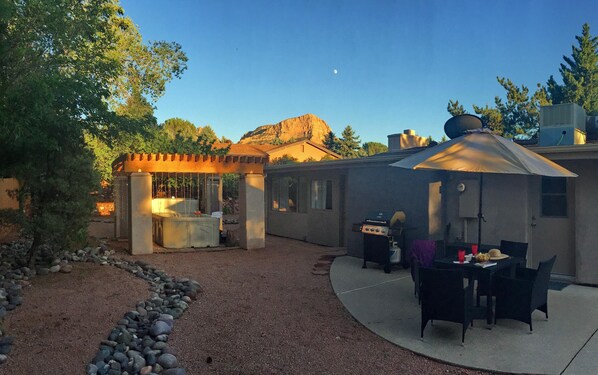 DESERT ROSE: Comfortable patio area with a hot tub on the rear of the home.