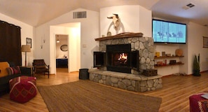 living room with wood burning fireplace