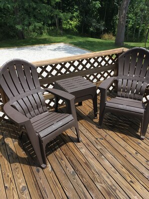 Comfortable Adirondack chairs & tables on the side deck