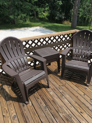 Comfortable Adirondack chairs & tables on the side deck