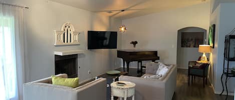 Living room w/ baby grand piano