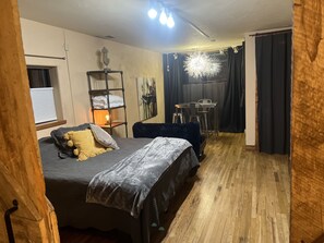 King bed in master bedroom, behind custom barn doors