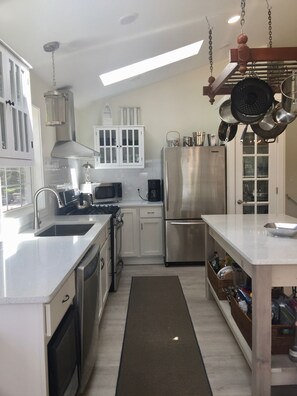 kitchen with stunning quartz counters,  island open to dining and living, views