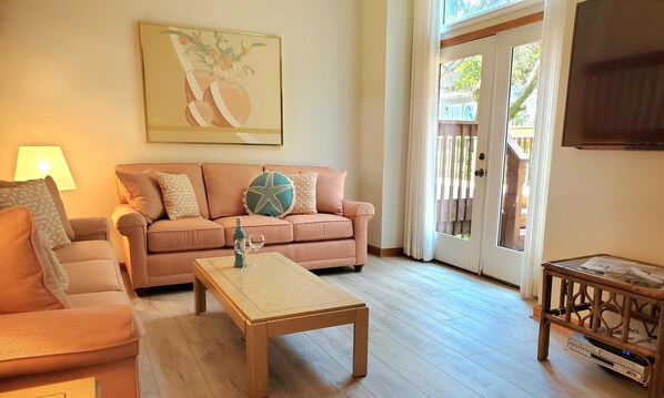 New Sunbrella Living Room Furniture and
   Hardwood Plank Flooring throughout