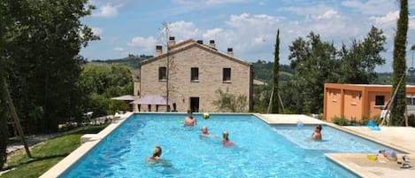 Pool for fun activities. House in the background and utility rooms to the right.