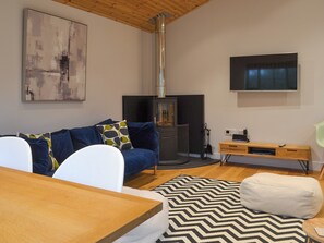 Comfortable lounge area with wood burner | Hen Harrier Lodge, St Columb Major, near Padstow