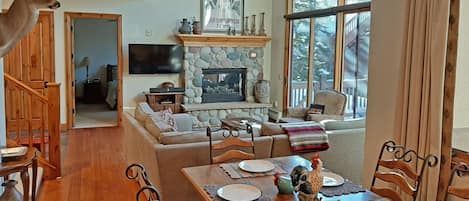 Open living area with fireplace. Walkout patio, seating for 10. 