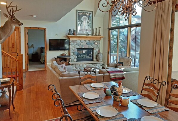 Open living area with fireplace. Walkout patio, seating for 10. 