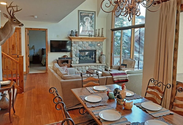 Open living area with fireplace. Walkout patio, seating for 10. 