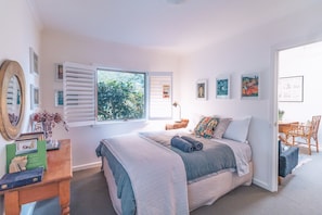 This bedroom also has a Queen bed, and  a portacot and child's high chair.