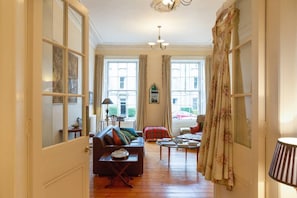 Hall way view into large drawing room 
