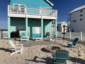 Large back yard with fire pit and charcoal grill 