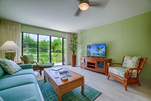 Living room opens to lush garden area.