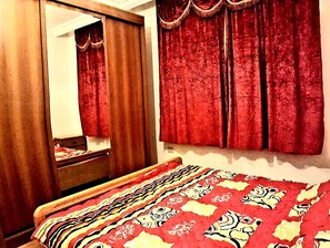 King Bedroom, Wardrobe with Mirror, 2 Pillows with Cases, Bed Spread and Sheet.