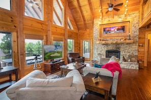 Living Room with HDTV and Stone Fireplace with Gas Logs