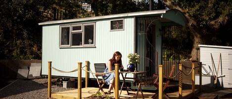 Still Waters is our luxury shepherd's hut with antique furniture and a toilet.