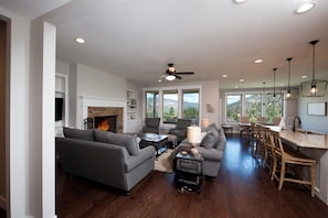 Living room with ceiling fan and fireplace