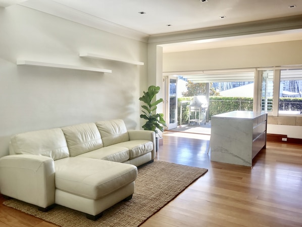Bright living room. 
Leather couch also opens out as a double bed