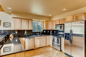 The kitchen is beautifully appointed with gorgeous granite counter tops and stainless appliances.