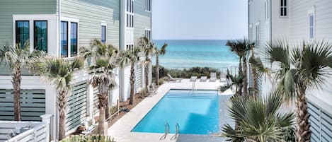 Beach Therapy view from the second floor living area balcony overlooking the community pool and beach access.