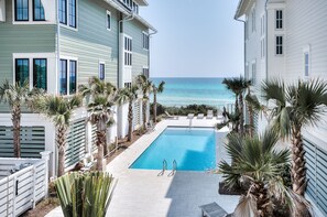 Beach Therapy view from the second floor living area balcony overlooking the community pool and beach access.
