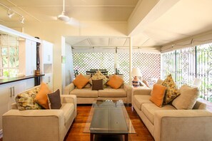 The comfortable open plan living room looks right out to the ocean