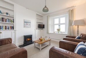 Triton, Bull Point Lighthouse:  Sitting room with a sea view and an electric wood burner effect stove