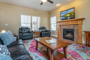 Beautiful family room with fireplace and TV and leather seating