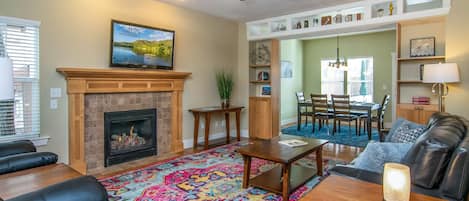 Beautiful cozy living room with fireplace, TV, and sofas