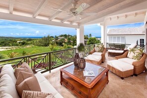 Comfortable patio with views of the Caribbean sea beyond