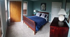 Bedroom: queen bed, bureau, closet