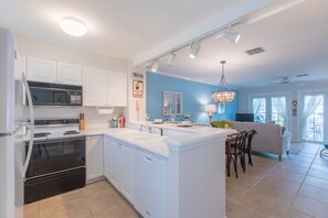 Kitchen is open to dining and living room areas