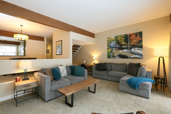 Well-appointed living room with plenty of seating and access to the backyard