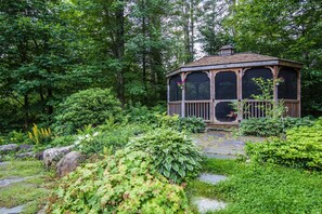 Screened in gazebo set among perennials