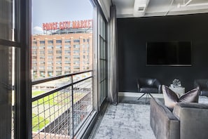 Living area with armchairs, wall-mounted TV, and amazing views.