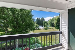 Balcony overlooking gardens, brook and lawn