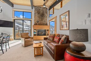 Living Room with Woodburning Fireplace & ceiling fan