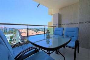 Large balcony with comfortable seating overlooks the pool and Yumbo Centre