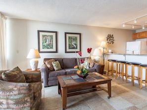 Comfortable living room with an open floor plan to the kitchen and lanai.