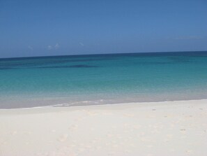 Our beach facing west on a windless day.  There are often waves on the beach that are great for body surfing.
