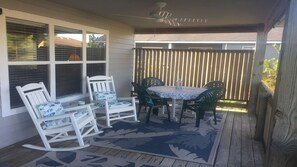 Covered deck with fan provides shade and privacy. 