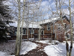 Lower part of back yard, looking to back deck with gas grill.