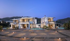 Cedar Bay Beachside Villas  by night-Ammos left- Lithos  middle-Kedros right