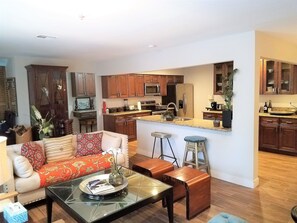 Living Room area adjacent to kitchen with an island to prepare food.