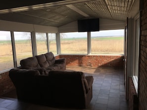 Sunroom with views of sunrise and sunset. Seats 7 (6 recliners)