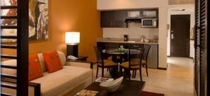 View from Bed area into living room towards dining and kitchenette and entry way