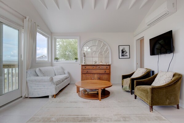Living room with vaulted ceilings and bay views