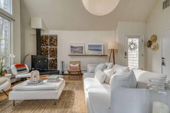 Living room with vaulted ceilings, wood burning stove and Sonos sound system. 