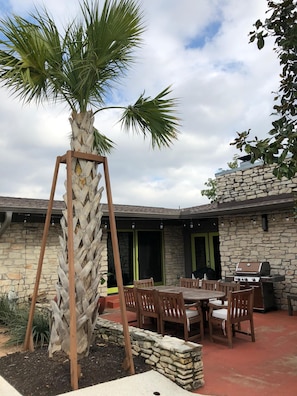 Our backyard patio has a dining table for 8 and a gas grill