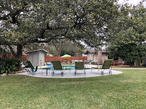 Lounge by the pool or enjoy the large, shaded backyard 